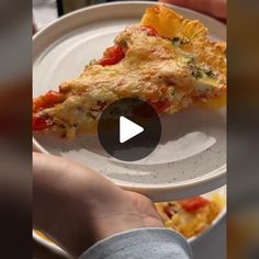 a person holding a plate with a slice of pizza on it