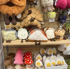 stuffed animals and other toys are on shelves in a toy store, including bread buns