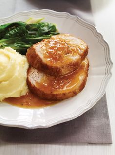 a white plate topped with mashed potatoes and meat