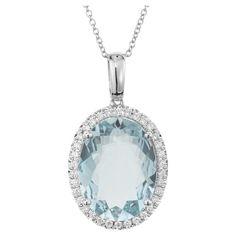 Stunning Aqua and diamond pendant necklace. This exquisite piece features a captivating 6.09ct oval aquamarine center gemstone complemented by dazzling halo of 34 round brilliant cut diamonds. The pendant is 14k white gold and completed with a 14k white gold 18 inch chain. 1 oval blue aqua, approx. 6.09cts 34 round brilliant cut diamonds, G-H VS SI approx. .23cts 14k white gold Stamped: 14k 4.9 grams Top to bottom: 27.3mm or 1.07 Inches Width: 15.4mm or .60 Inches Depth or thickness: 8.1mm Pleas Antique Wedding Bands, Diamond Sapphire Engagement Ring, Antique Engagement Rings Vintage, Vintage Sapphire, Antique Bracelets, Diamond Engagement Rings Vintage, Halo Pendant, Jewelry Picture, Gold Bracelet Cuff