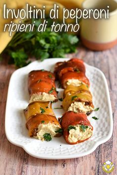 lobster wrapped in cheese and garnished with parsley on a white platter