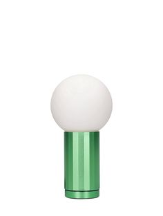 a green table lamp with a white ball on it's base and a light bulb in the middle