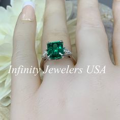 "May Birthstone Ring, Emerald Cut Engagement Ring, Moissanite Engagement Ring, Three Stone Ring, Large Cocktail Ring, 14k White Gold Ring #6722 Emerald is the birthstone of May -Approximate total carat weight: ctw diamond equivalent -Center Stone Size: 10x8mm approx. 3.55ct diamond equivalent -Center Stone Shape: emerald cut -Gem Type: lab created emerald -Stone Clarity: VS2 -Stone Color: lively medium green, eye-clean -Moh's Scale: 8.5 hardness -Accent Stones: 2 pear shapes -Accent Stones Size: Princess Cut Moissanite Emerald Ring With Prong Setting, Diamond Sapphire Ring With Accent Stones For May Birthstone, Diamond Ring With Prong Setting For May Birthstone, May Birthstone Sapphire Ring With Diamond Accent Stones, May Birthstone Princess Cut Ring With Center Stone, Radiant Cut Diamond Ring For May Birthstone, Princess Cut Ring With May Birthstone, Fine Jewelry Moissanite Emerald Ring With Accent Stones, Asscher Cut Moissanite Rings With Accent Stones