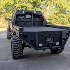 a large black truck parked in a parking lot