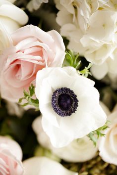 an arrangement of white and pink flowers