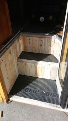 the steps are made out of wood and have black rubber mats on them for extra storage