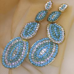 Very Well Complete For Superior Quality And Longevity Brand New Fashion Crystal/ Rhinestone Earrings For Women, Ladies, And Bridal Silver Needle. Nickel Free And Lead Free Material. Setting With Crystal, Rhinestones, Zircon Etc. Style#Dangle102 Color: Gold, Blue Weight: 25g Width: 25mm Height: 85mm Bundle 2+ For 20% Off Turquoise Chandelier Earrings For Party, Turquoise Dangle Earrings For Party, Blue Metal Earrings With Rhinestones, Light Blue Drop Earrings For Party, Turquoise Drop Crystal Earrings For Party, Blue Jeweled Dangle Crystal Earrings, Blue Jeweled Drop Earrings, Turquoise Gemstone Earrings, Owl Earrings Studs