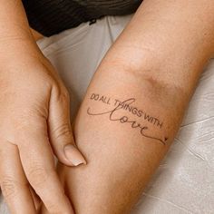 a woman's arm with the words do all things with love written on it