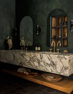 a bathroom with marble counter tops and sinks