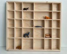 several wooden shelves with different types of toy animals on them