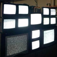 several televisions are stacked on top of each other