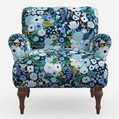 an upholstered chair with blue flowers on it