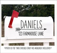 a white mailbox with a red arrow sticking out of it's side and the name danielles 123 farmhousehouse lane