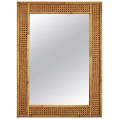 a wooden frame mirror with an intricate design on the front and sides, made out of bamboo