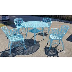 an outdoor table and chairs with blue paint