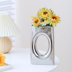 a vase with sunflowers in it sitting on a table