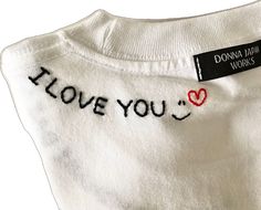 a white shirt with the words i love you written on it