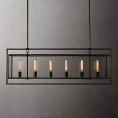 an industrial style chandelier with five lights hanging from it's center bar