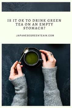 a woman holding a cup of green tea with the caption is it ok to drink green tea on an empty stomach?