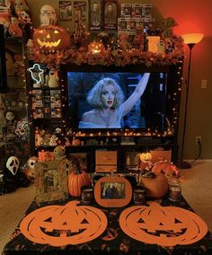 a living room decorated for halloween with pumpkins and decorations