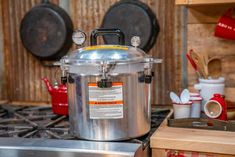 a stainless steel pot sitting on top of a stove next to a wooden countertop