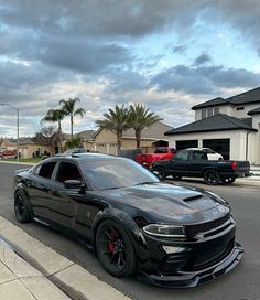 a black car is parked on the side of the road