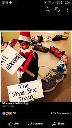 an image of a elf holding signs on the table with other items around him that say i'll gommt the shoe - shop train