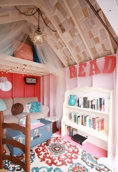 an image of a bedroom with pink walls and blue accents on the bed, bookshelf