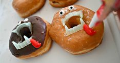 there are donuts with fake teeth and mouths on them