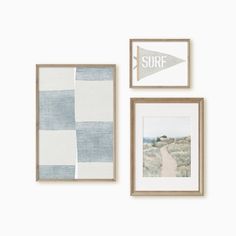 three framed pictures hang on the wall next to each other, one with an arrow