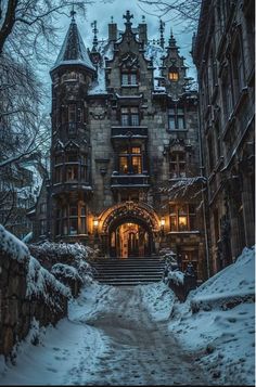 an old building with snow on the ground and stairs leading up to it, at night