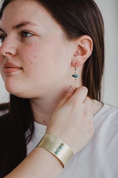 Make a simply beautiful statement with these handmade brass and turquoise earrings. *Due to the unique nature of these turquoise stones, the shade of turquoise may vary slightly from the photos. If you have a preference for a darker or lighter turquoise, please make note of that at checkout and we will do our best to accommodate.*Size: 2.5"Materials: Solid brass, turquoise Commonform’s mission is to keep jewelry wearers kitted out in brass, silver and stones. Combining a love for creation and gi Adjustable Turquoise Brass Jewelry, Turquoise Hand Forged Drop Earrings, Turquoise Brass Jewelry, Artisan Turquoise Brass Jewelry, Turquoise Nickel-free Brass Jewelry, Handmade Turquoise Brass Earrings, Turquoise Brass Jewelry With Ear Wire, Turquoise Brass Drop Earrings, Hand Forged Turquoise Brass Jewelry