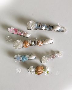 five seashells are arranged on a white surface