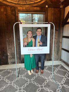 a man and woman standing next to each other in front of a sign that says celebration event