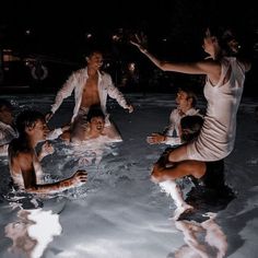 a group of people are in the water together