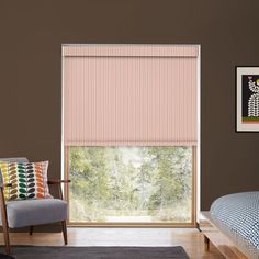 a bedroom with a bed, chair and window covered in pink roman blind shades on the windowsill