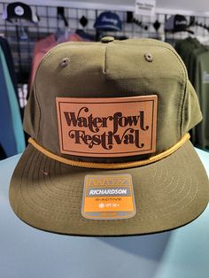 a hat with the words waterfowl festival on it is sitting on a table