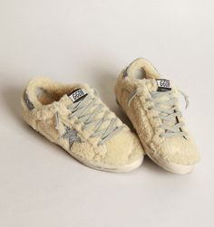 These Golden Goose super stars are a low top style with a fur exterior, and a glittery star to match the heel tab. Main material: 95% sheepskin leather, 4% PVC, 1% cotton Lining: 63% sheepskin leather, 37% cowhide leather Sole: 100% rubber Shearling upper Glittery GGDB star Glittery heel tab Vintage finish Luxury Winter Sneakers, Peter Sheppard Shoes, Golden Goose Yeah Sneakers, Fur Sneakers, Athleisure Trend, Affordable Shoes, Shoe Wishlist, Goose Shoes, Mid Top Sneakers