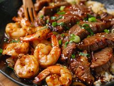 a close up of food on a plate with chopsticks in it and shrimp