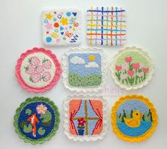 nine embroidered coasters are arranged on a white surface