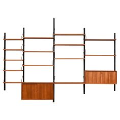 three bookshelves, one with two doors and the other with shelves on each side