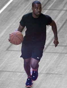 a man holding a basketball on top of a court