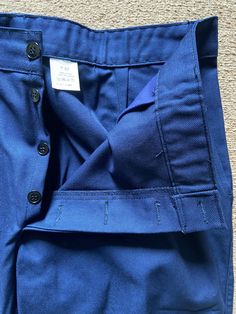 Traditional French Work Trousers (Bleu de travail) Old French Dark  Indigo Blue Trousers. Material: Sanforized Polycotton Made in France Hard-wearing, High Waisted Trousers. The pants have front hip pockets, back change pocket and a side ruler pocket. Button fly (Concealed Buttons).  Flat fronted. Pressed centre seam. Colour: Indigo Blue (Dark Navy Blue) Label size -  French 52 Size W38 L31 Measurements Laid Flat: Waist 19" Inseam 31" Hips 22" (Laid Flat) Front Rise 12" Leg Opening 10"   These t Blue Trousers With Welt Pockets, Vintage Indigo Bottoms With Pockets, Indigo Denim Trousers, Blue Five-pocket Pants For Workwear, Blue Relaxed Fit Trousers, Work Trousers, Blue Trousers, Dark Navy Blue, Indigo Blue