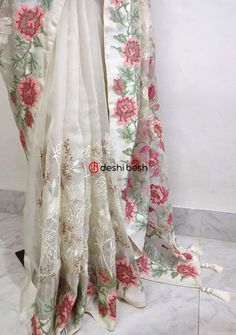 This exclusive boutique designer hand made Muslin saree is a perfect and unique choice for your occasional and party wear. All Over Delicate Neat Flower Embroidery, and Tassels Work. Matching Running Blouse Piece. Color: There might be slight color variation due to lightings and flashes while photo shooting. The color may also vary because of different screen resolutions. Wash Care: Dry Clean Only. Note: This is a hand made boutique saree and could take 1 to 2 weeks longer than the estimated dis Semi-stitched Art Silk Saree With Floral Embroidery, Tissue Silk Pre-draped Saree With Floral Embroidery For Festivals, Designer Georgette Saree With Floral Embroidery, Off White Art Silk Saree With Cutdana, Embroidered White Pre-draped Saree For Festivals, White Organza Blouse With Floral Embroidery, White Silk Thread Traditional Wear For Festivals, Georgette Saree With Floral Embroidery, Georgette Saree With Floral Embroidery For Wedding