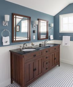 a bathroom with two sinks and mirrors in it