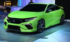 a bright green car is on display at an auto show