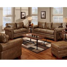 a living room filled with brown furniture and wooden floors