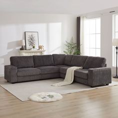 a living room with a sectional couch and rug