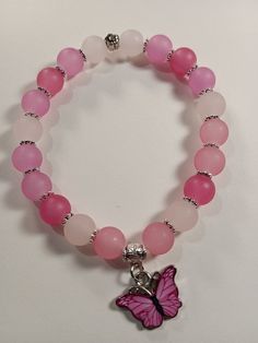 bracelet idea 🦋🩷✨ Pink Butterfly Bracelet, Pink Glass Bead Bracelet, Pink Bracelets Ideas, Pink Charm Bracelet With Colorful Round Beads, Pink Rose Quartz Round Stretch Bracelet, Pink Rose Quartz Stretch Bracelet, Pink Stretch Bracelet With Spacer Beads As Gift, Adjustable Pink Charm Bracelet With 8mm Beads, Pink Charm Bracelet With Colorful Beads For Jewelry Making