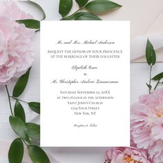 a wedding card with pink flowers and greenery